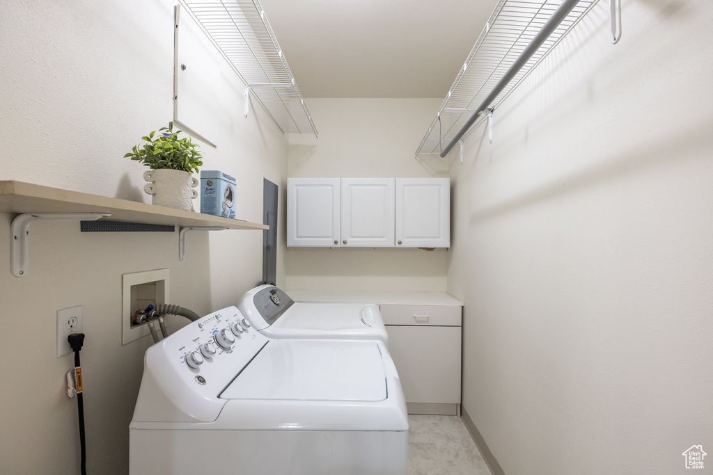Laundry room with baseboards and washer and clothes dryer