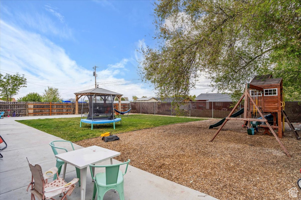View of play area featuring a yard, a patio, a gazebo, and a fenced backyard