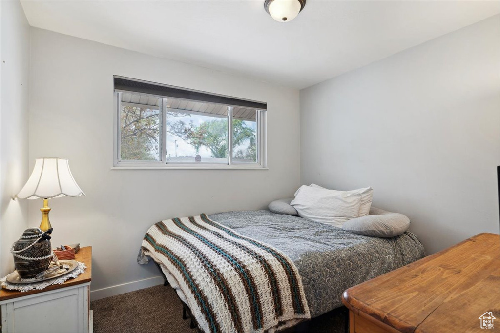 Carpeted bedroom featuring baseboards