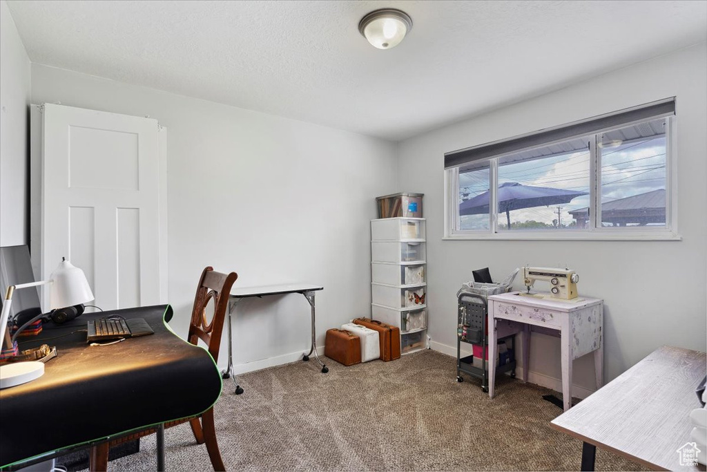 Carpeted office space featuring baseboards
