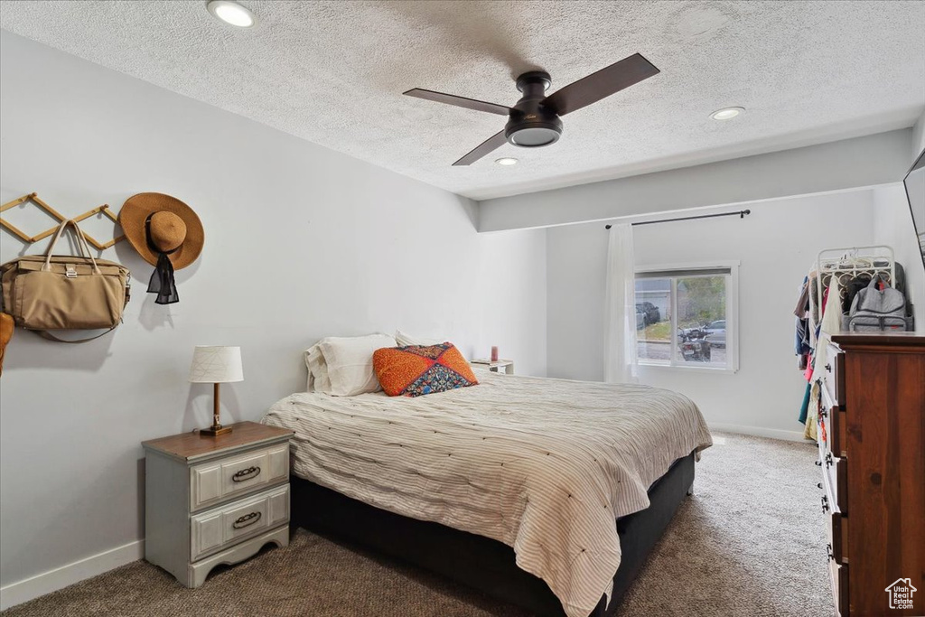 Bedroom featuring carpet flooring, recessed lighting, baseboards, and a textured ceiling