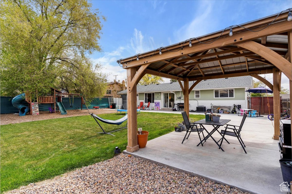 View of patio / terrace with fence, central AC unit, a gazebo, and a playground