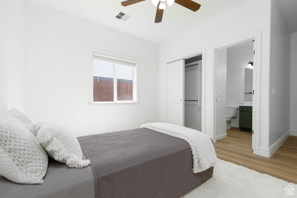Bedroom featuring visible vents, a closet, baseboards, ceiling fan, and light wood-type flooring