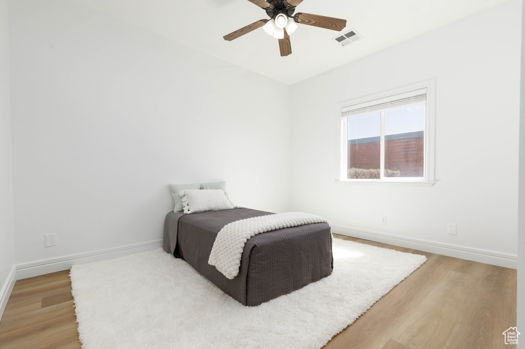 Bedroom with visible vents, baseboards, and light wood-type flooring