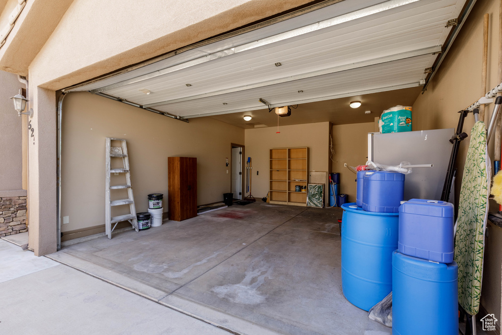 Garage with a garage door opener and refrigerator