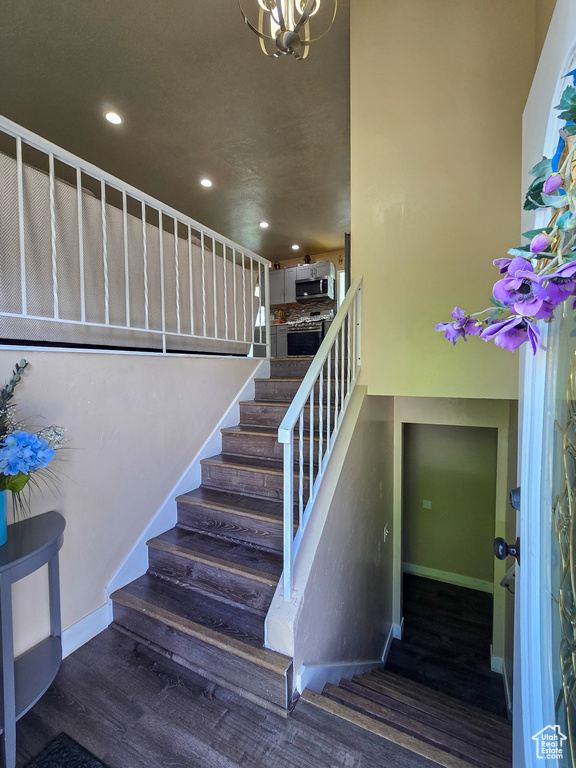 Stairs with recessed lighting, baseboards, and a chandelier