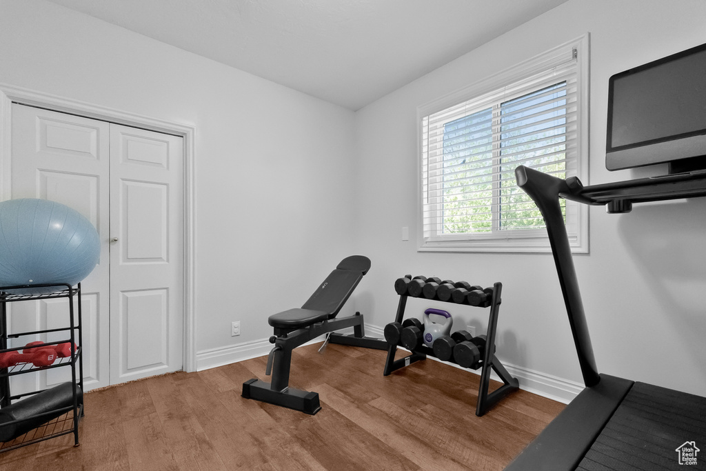 Exercise room featuring baseboards and wood finished floors