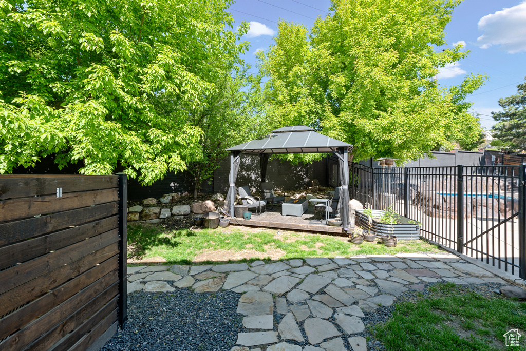 Fenced backyard with a gazebo and a patio