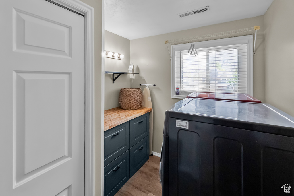 Washroom featuring washer / dryer, laundry area, light wood-style flooring, and visible vents