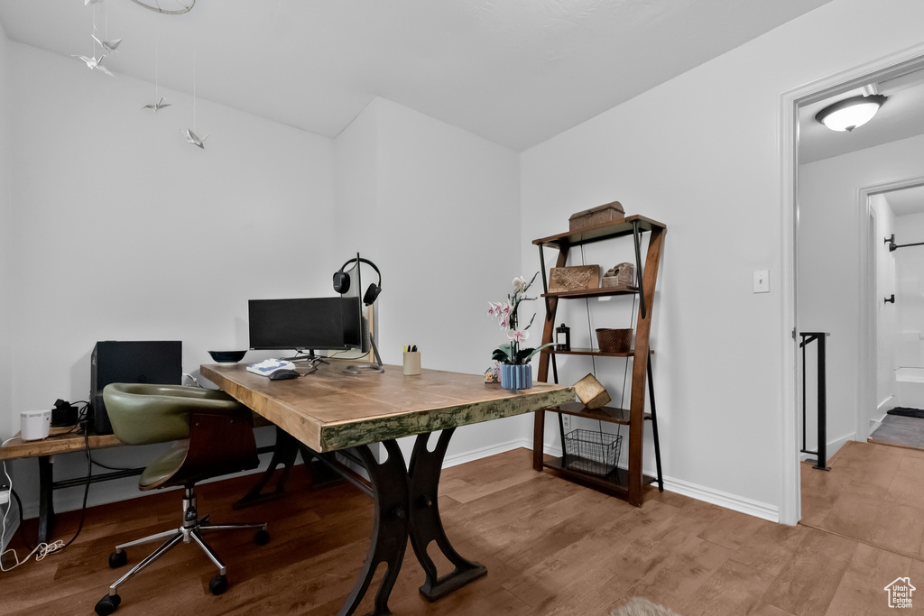 Office area featuring baseboards and wood finished floors
