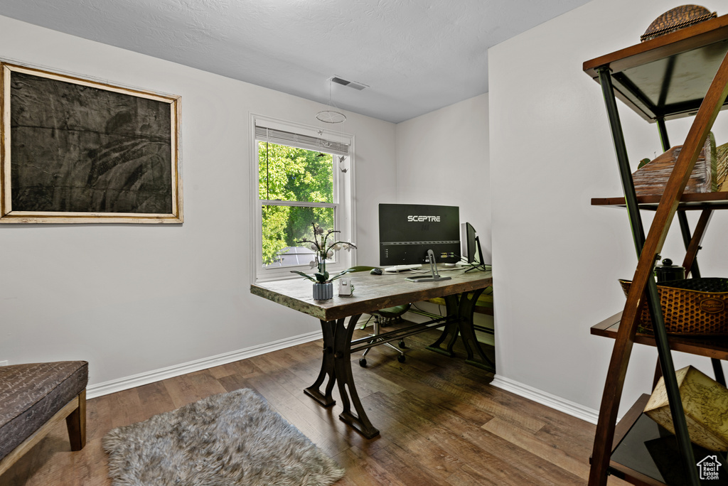 Home office featuring baseboards and wood finished floors