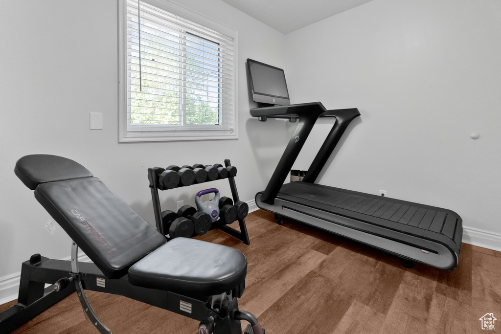Exercise room featuring baseboards and wood finished floors