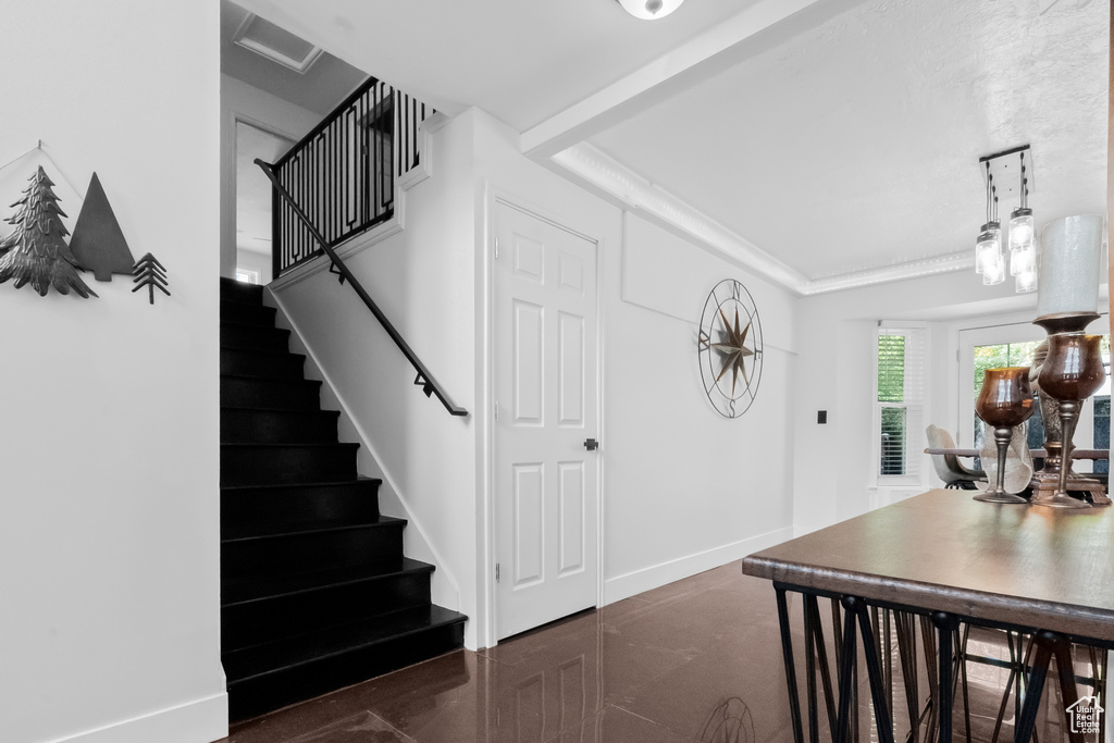Entrance foyer with baseboards and stairway