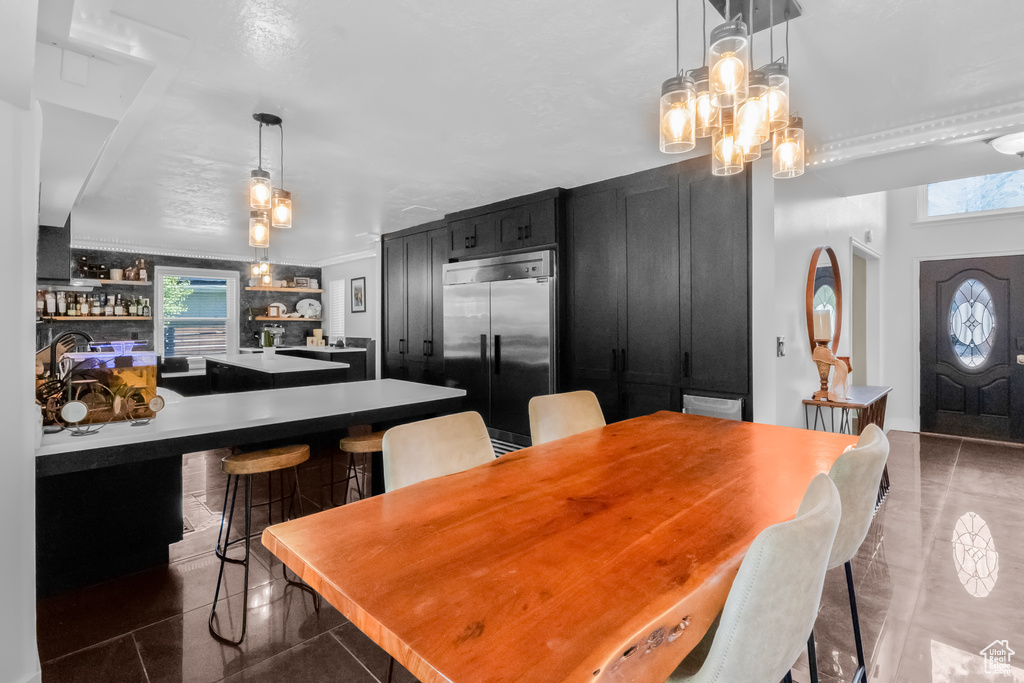 Dining area featuring an inviting chandelier and crown molding