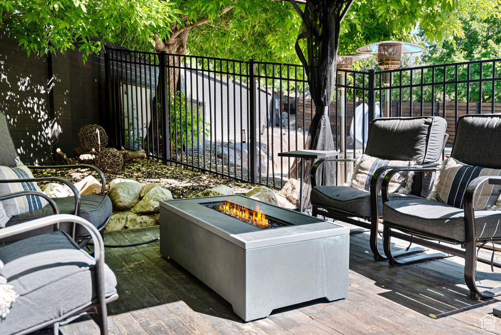View of patio with a fire pit and a deck
