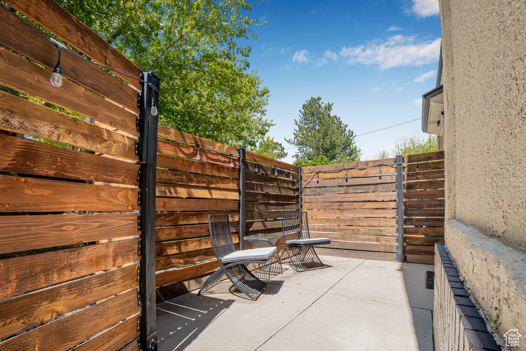 View of patio featuring fence