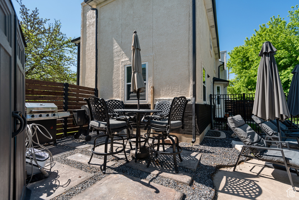 View of patio featuring grilling area and outdoor dining area