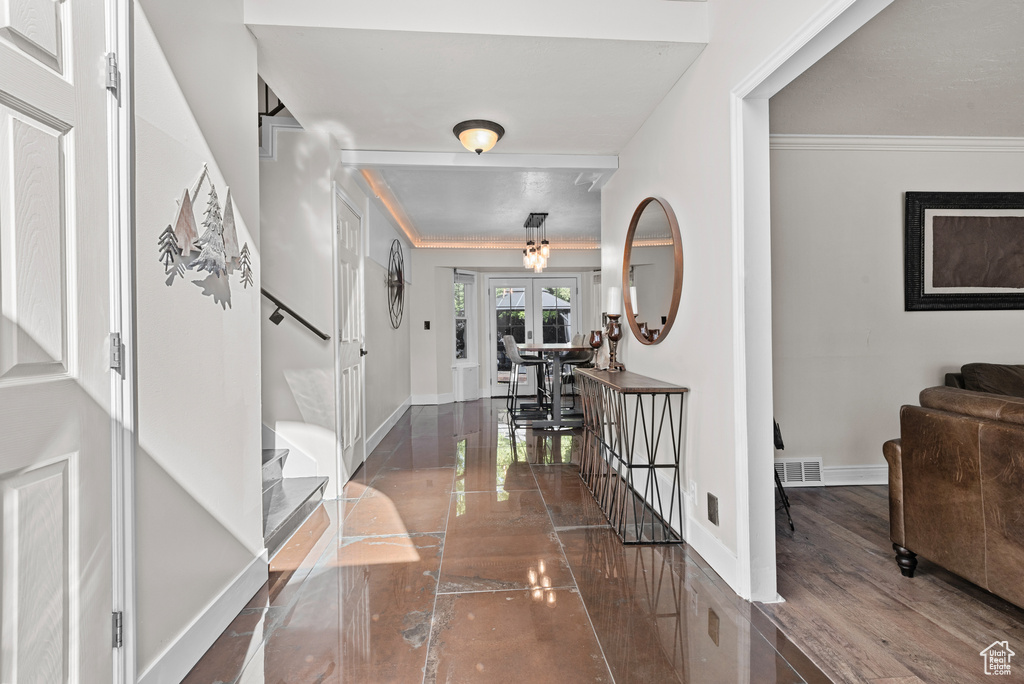 Foyer featuring stairs, french doors, baseboards, and crown molding