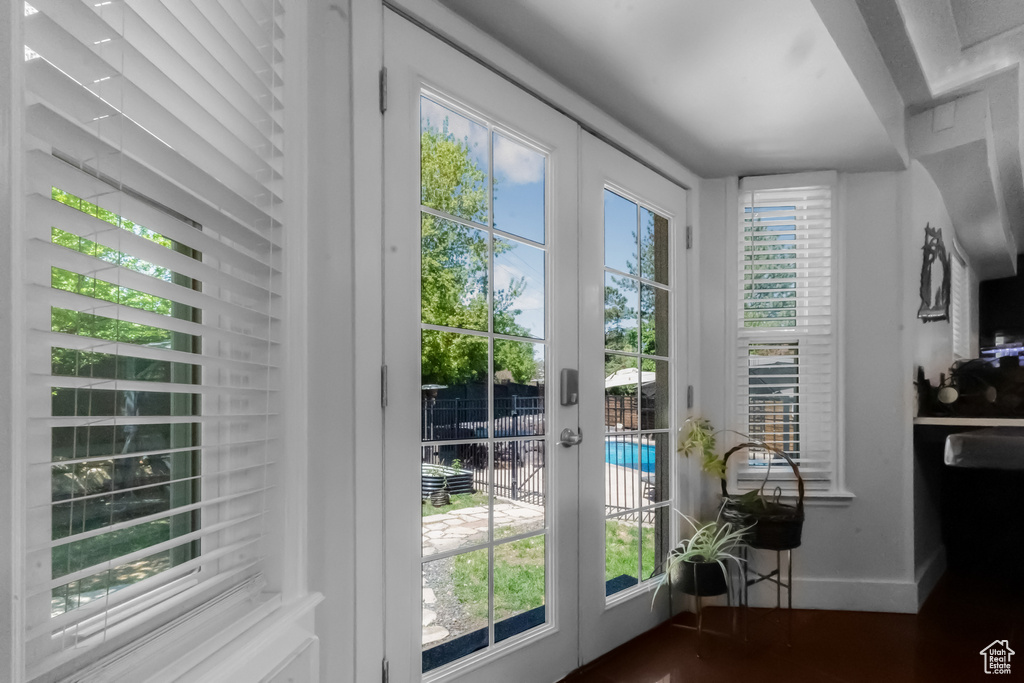 Entryway featuring french doors, baseboards, and a healthy amount of sunlight
