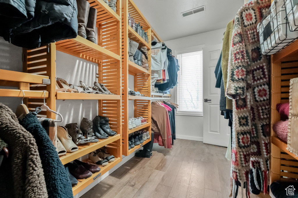 Walk in closet with visible vents and hardwood / wood-style floors