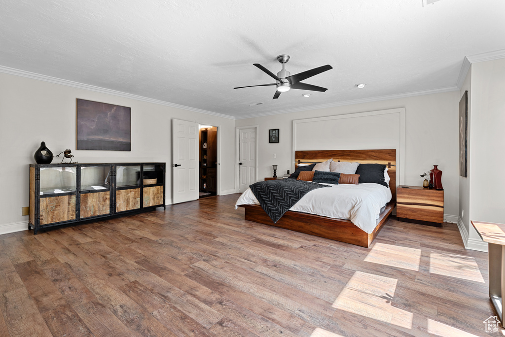Bedroom featuring wood finished floors, crown molding, baseboards, recessed lighting, and a ceiling fan