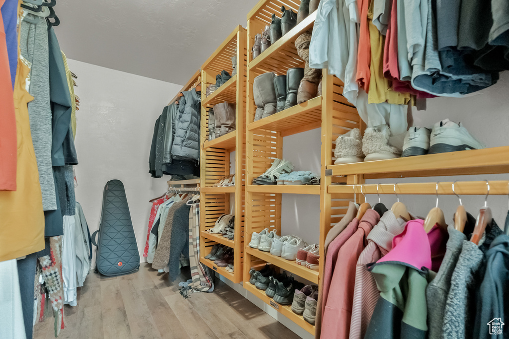Walk in closet with wood finished floors