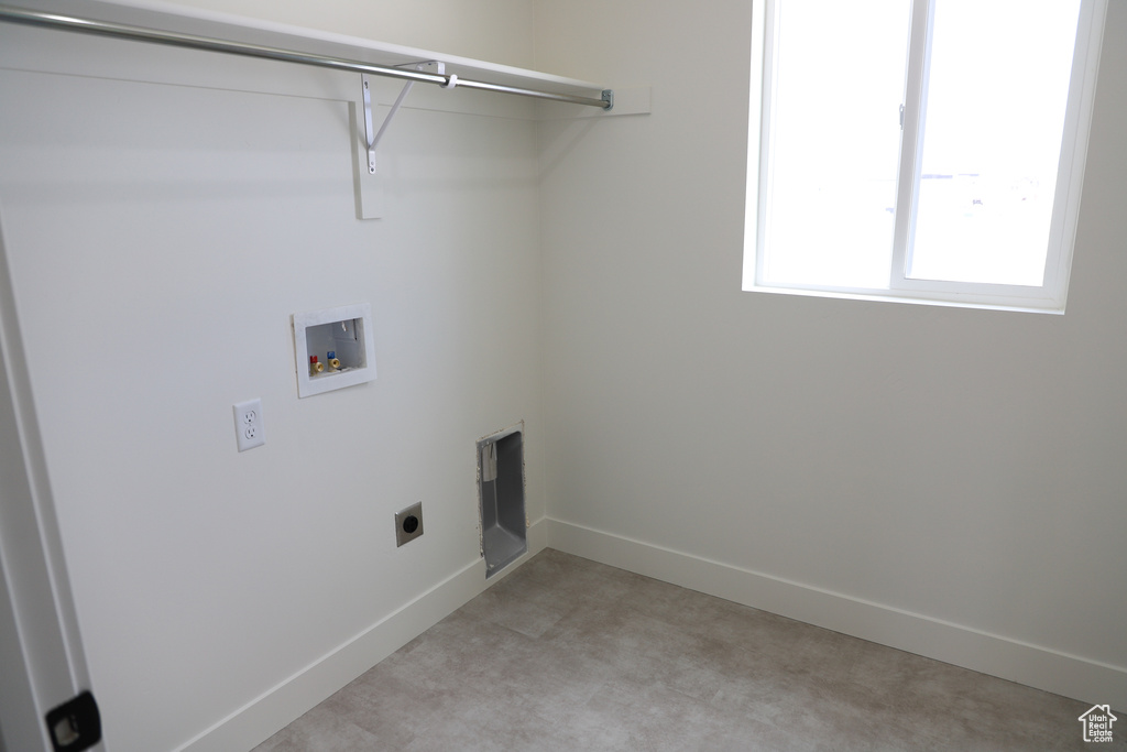 Washroom with laundry area, hookup for a washing machine, baseboards, and hookup for an electric dryer