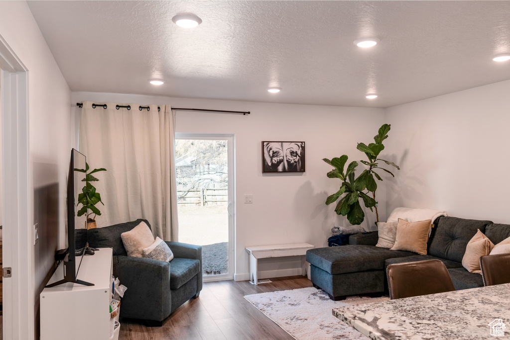 Living area with recessed lighting, baseboards, and wood finished floors