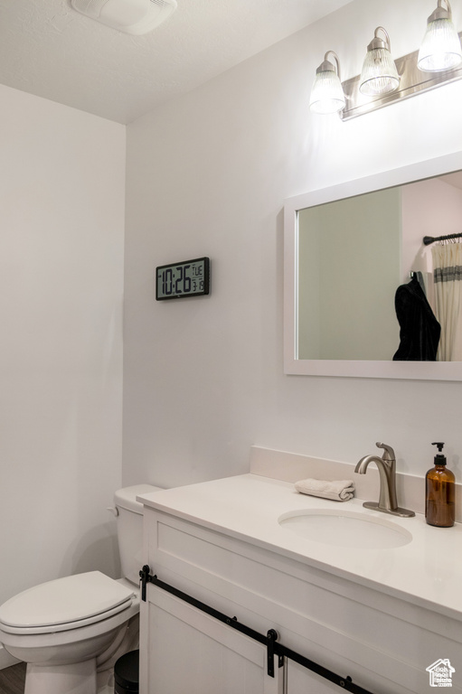 Bathroom featuring vanity and toilet