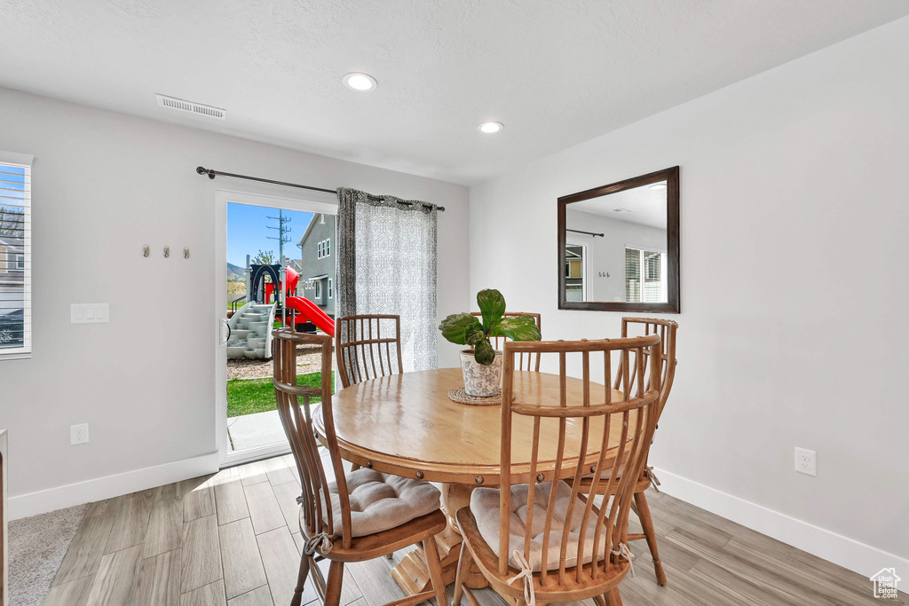 Dining room with baseboards, recessed lighting, light wood-style flooring, and visible vents