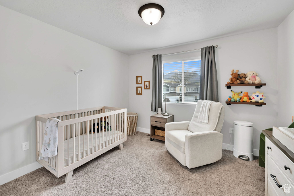Bedroom with baseboards and light carpet
