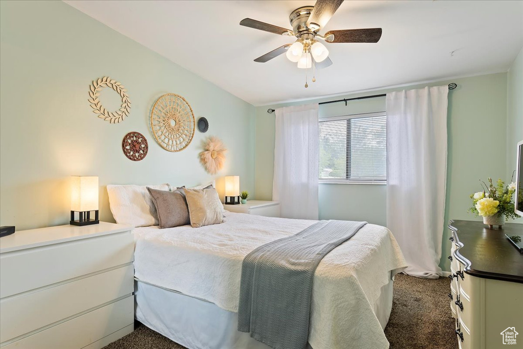 Bedroom with a ceiling fan and carpet flooring