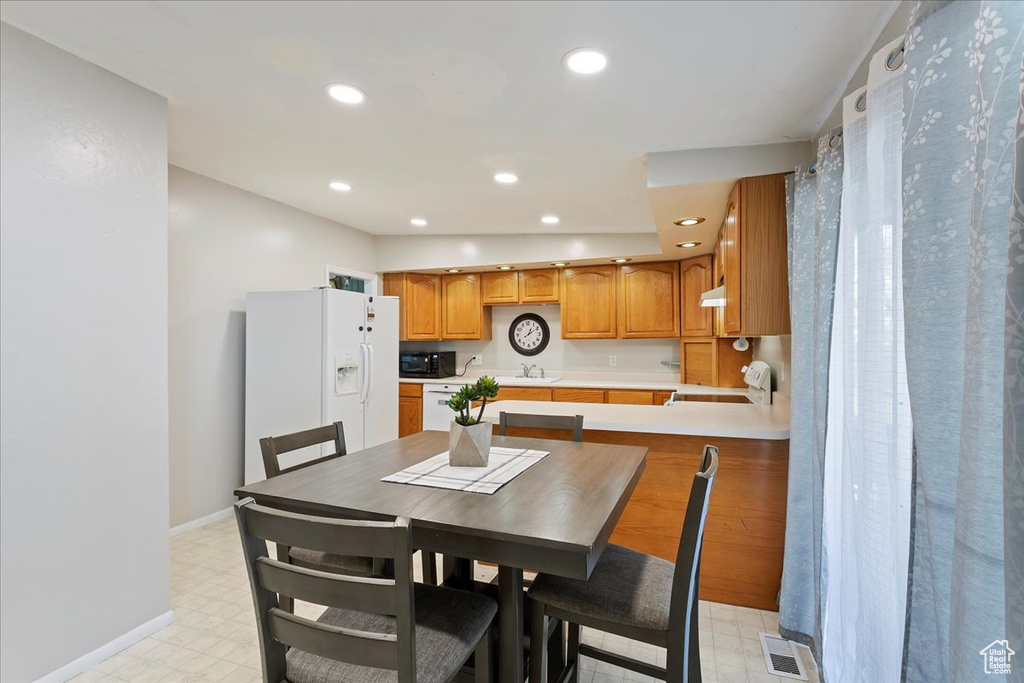 Dining area featuring recessed lighting, baseboards, visible vents, and light floors