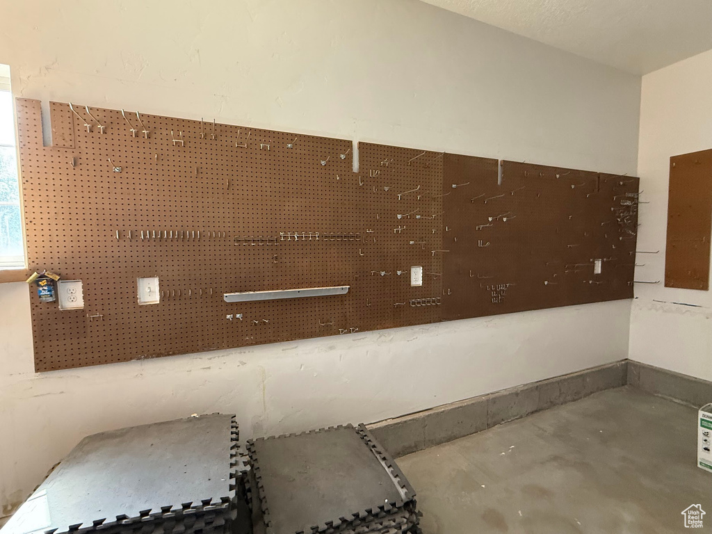Detailed view of unfinished concrete floors and electric panel