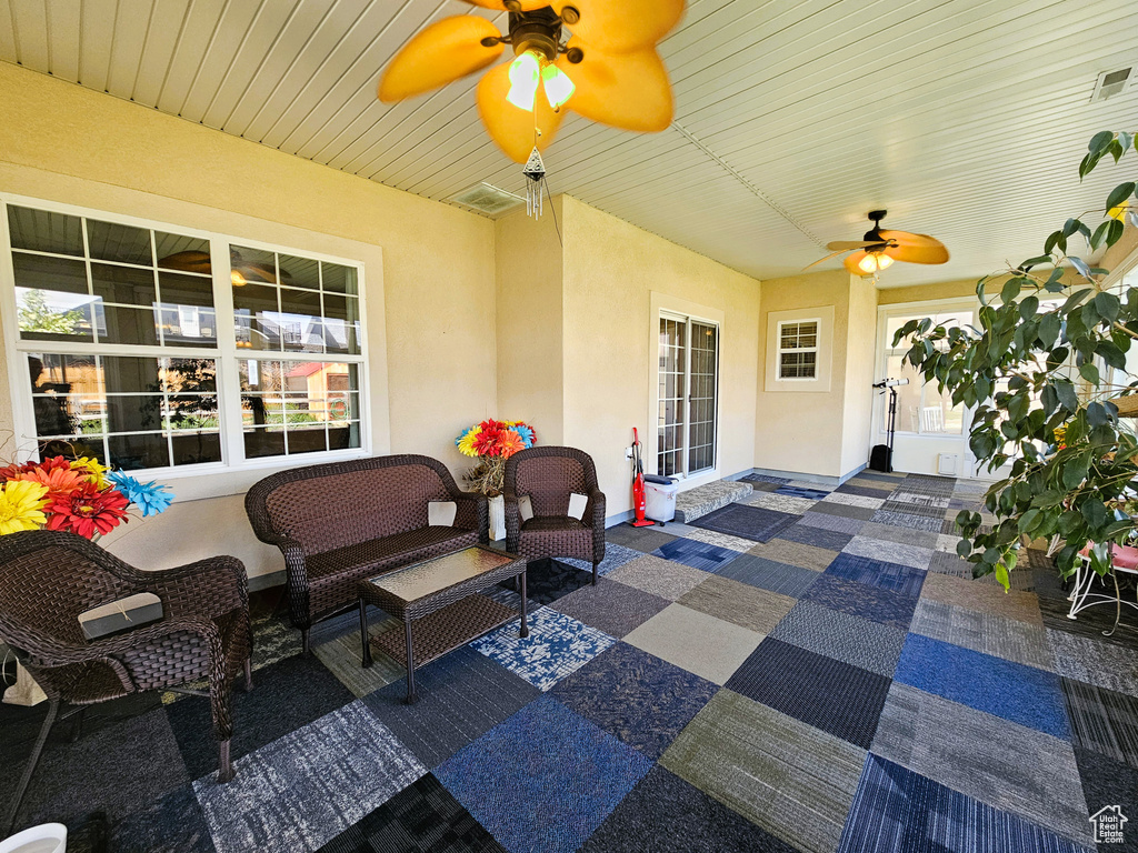 Sunroom with an outdoor living space, a ceiling fan, and a wealth of natural light