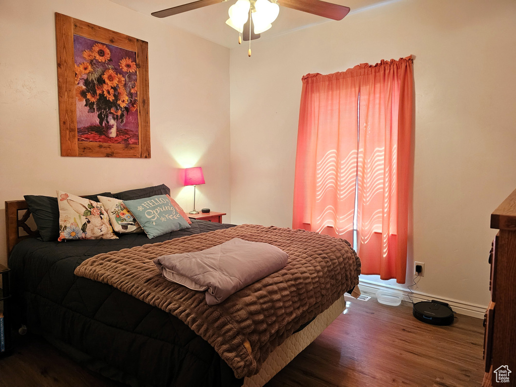Bedroom with baseboards, ceiling fan, and wood finished floors