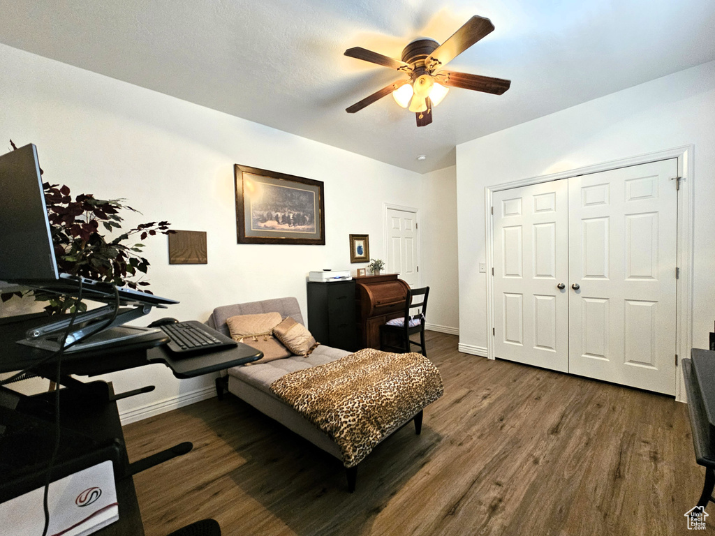 Interior space with baseboards, a ceiling fan, and wood finished floors