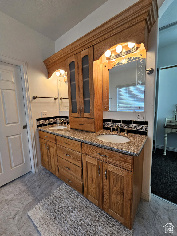 Full bath featuring a sink and double vanity