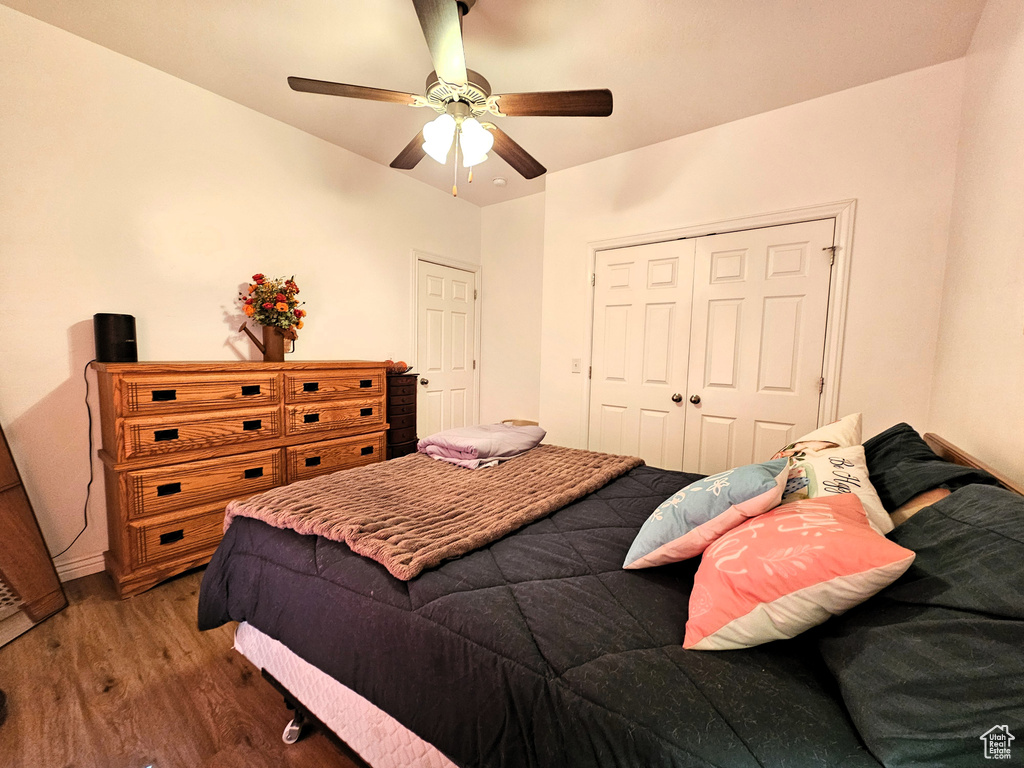 Bedroom with a ceiling fan, a closet, and wood finished floors