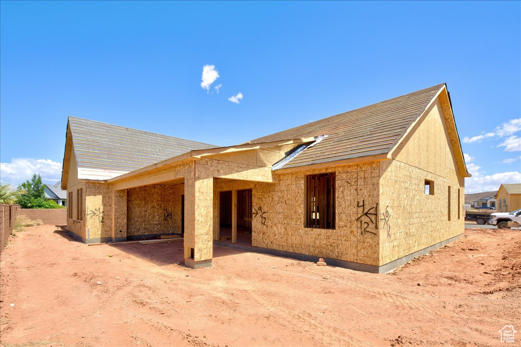 Rear view of property featuring fence