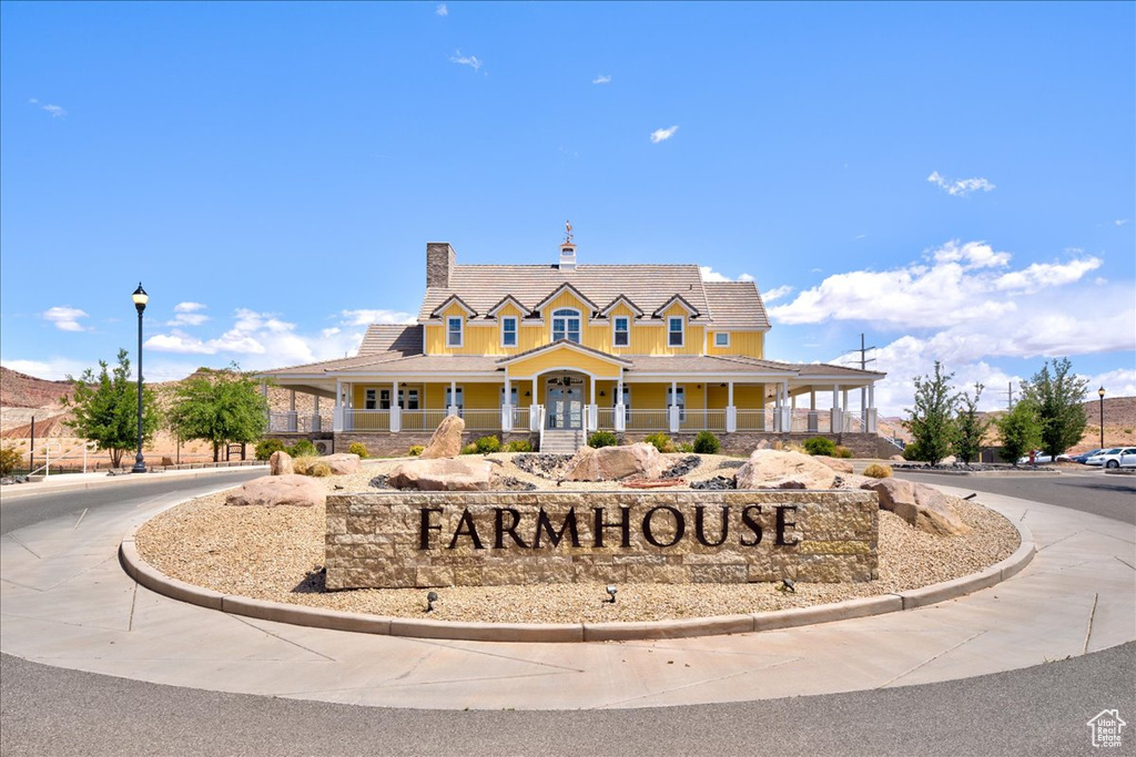 View of front of house featuring a porch and a chimney