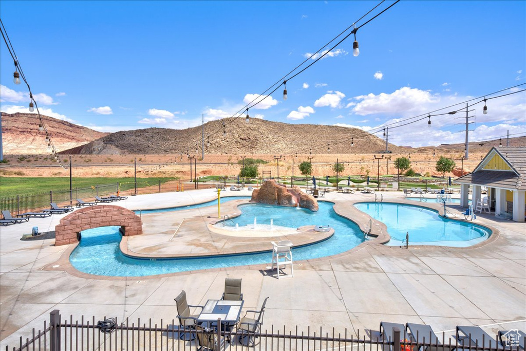 Community pool with a mountain view and a patio area