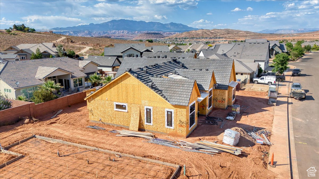 Exterior space with a residential view, a mountain view, and a tiled roof