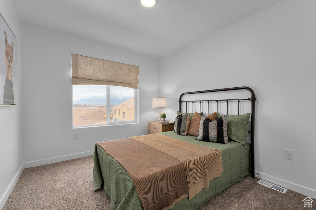 Bedroom with visible vents, baseboards, and carpet floors