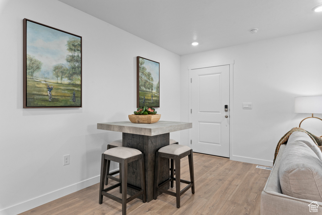 Dining area featuring recessed lighting, baseboards, light wood finished floors, and visible vents