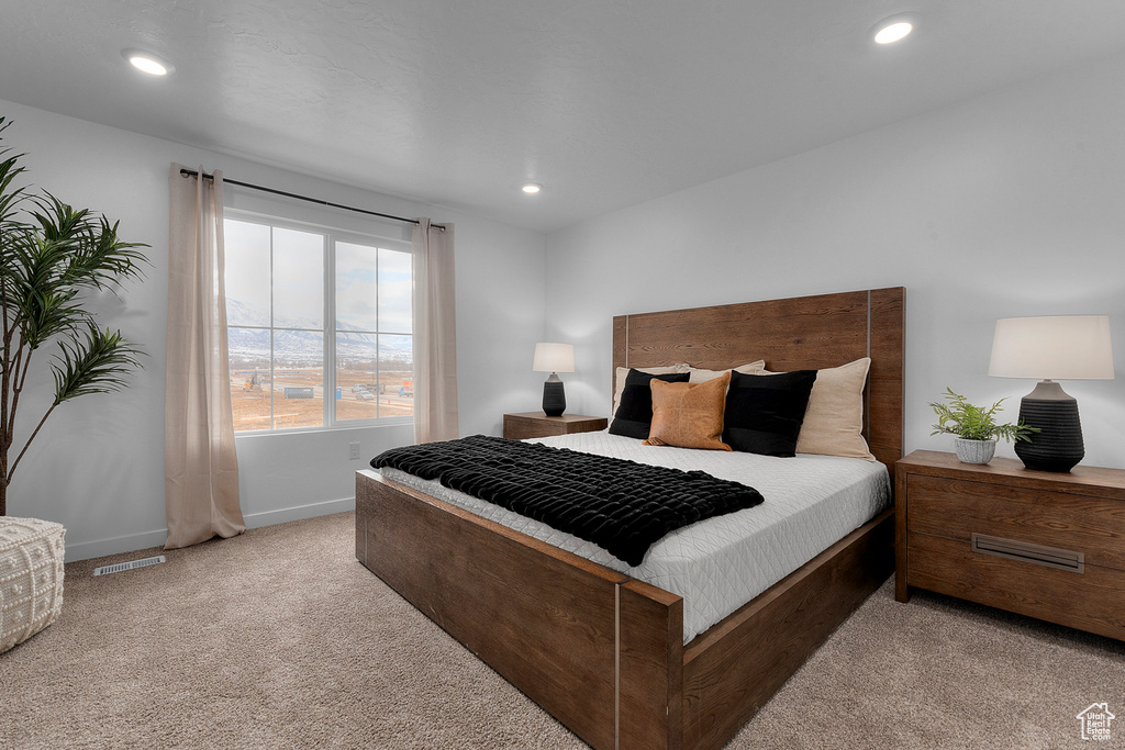 Carpeted bedroom with recessed lighting, baseboards, and visible vents