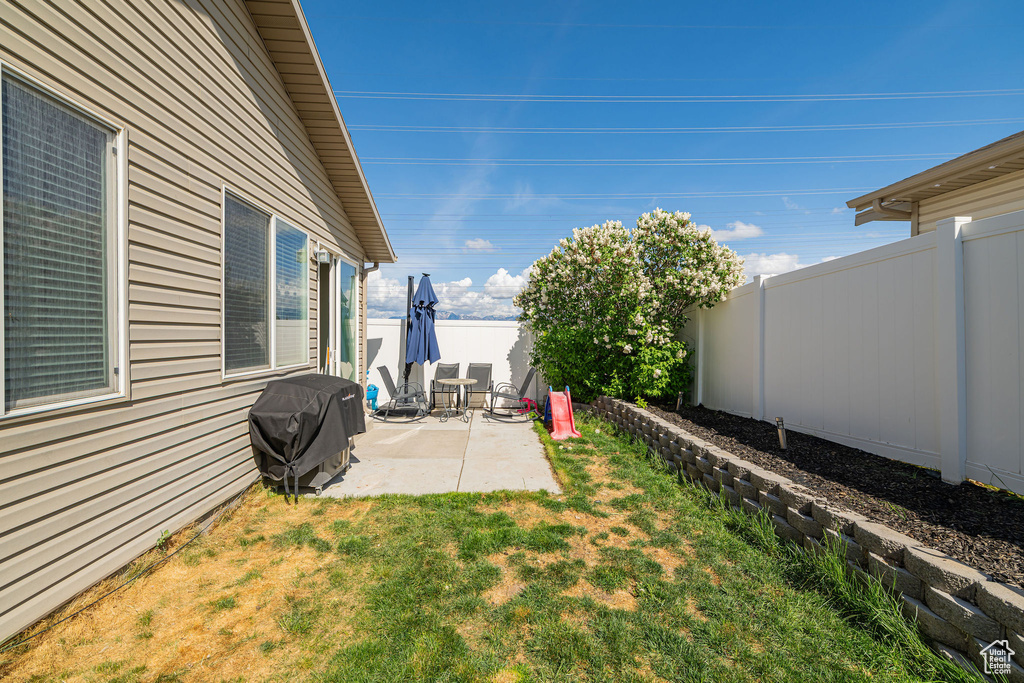 View of yard with a patio and a fenced backyard