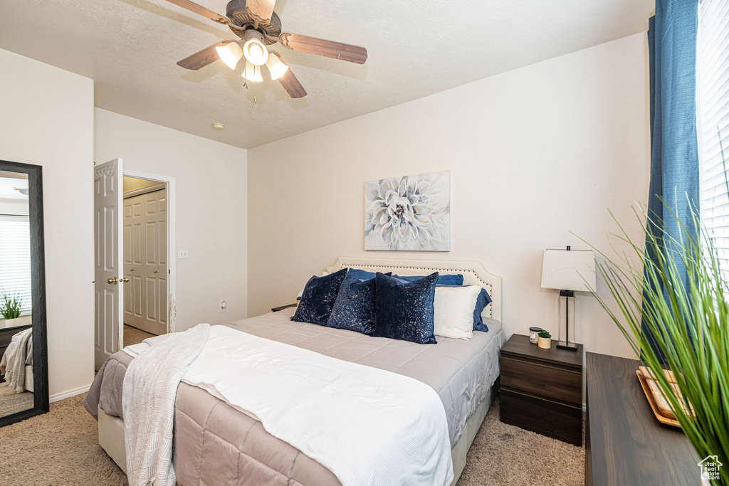 Carpeted bedroom with ceiling fan