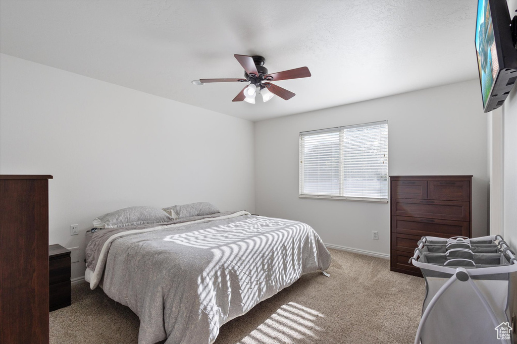 Bedroom featuring carpet floors, a ceiling fan, and baseboards