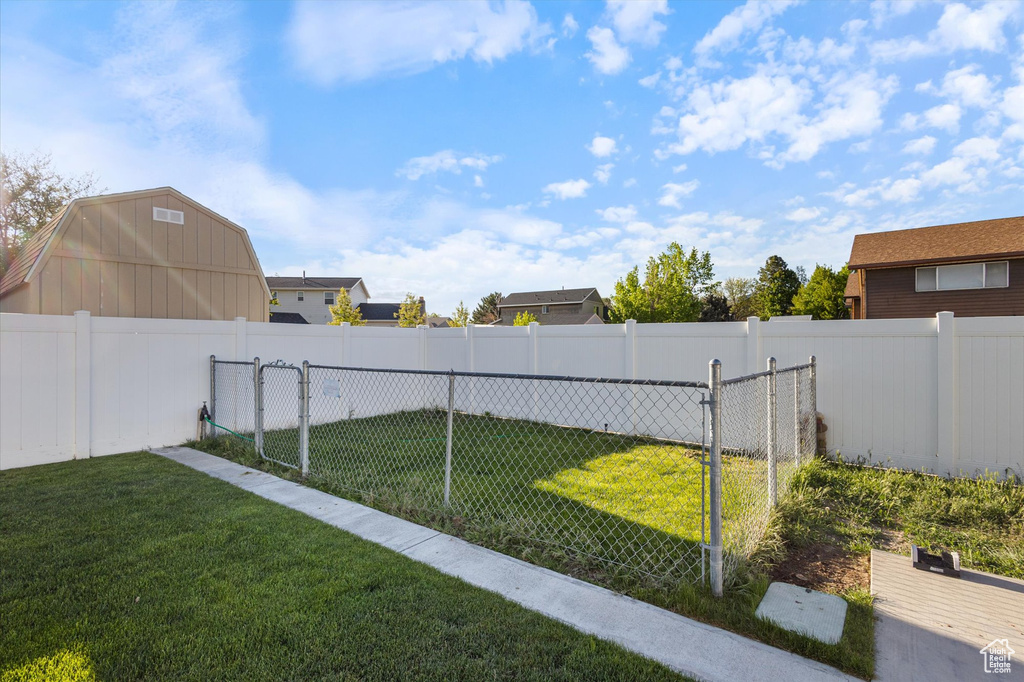 View of yard with fence and a gate